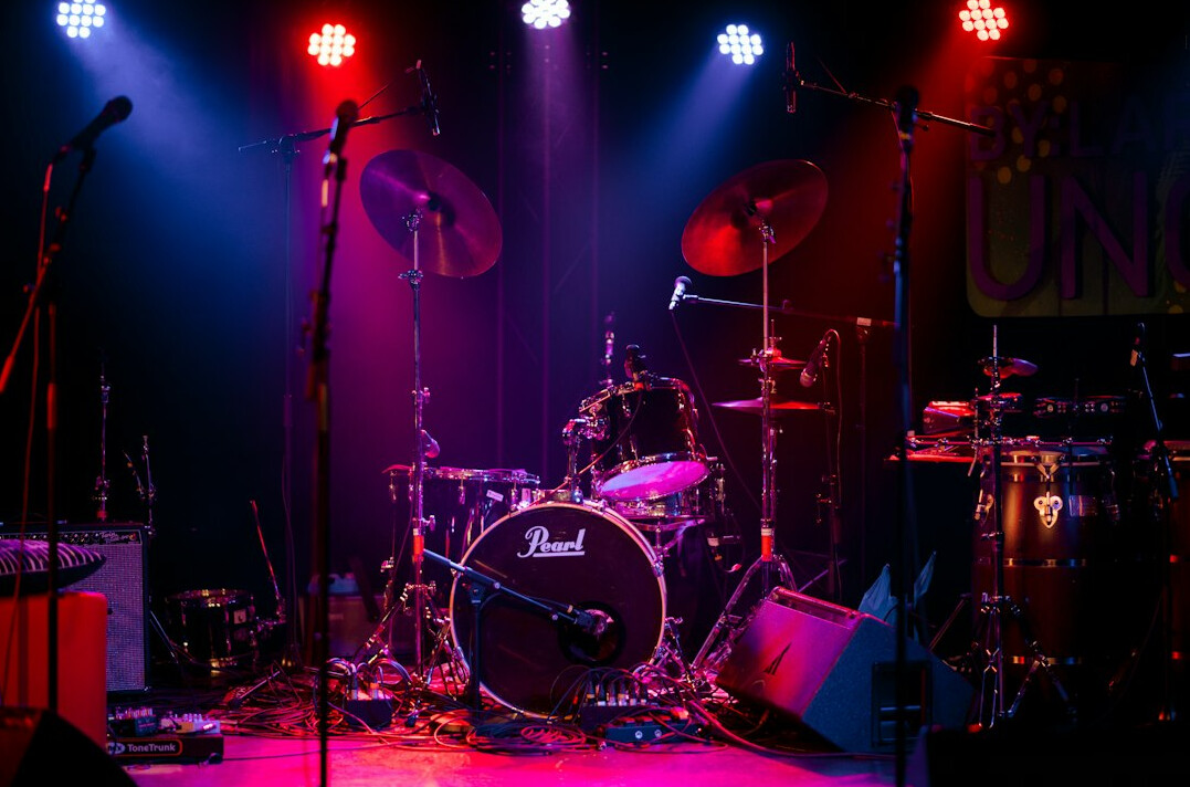 Concert stage with colorful lights and a microphone stand
